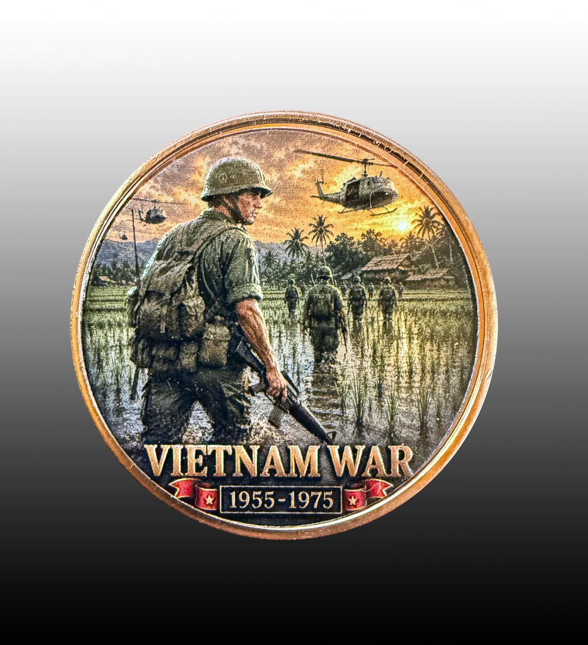 A circular Vietnam War commemorative coin or medallion featuring a soldier wading through water with helicopters overhead, plus the text 'VIETNAM WAR 1955-1975' at the bottom, shown on a gray-to-black gradient background.